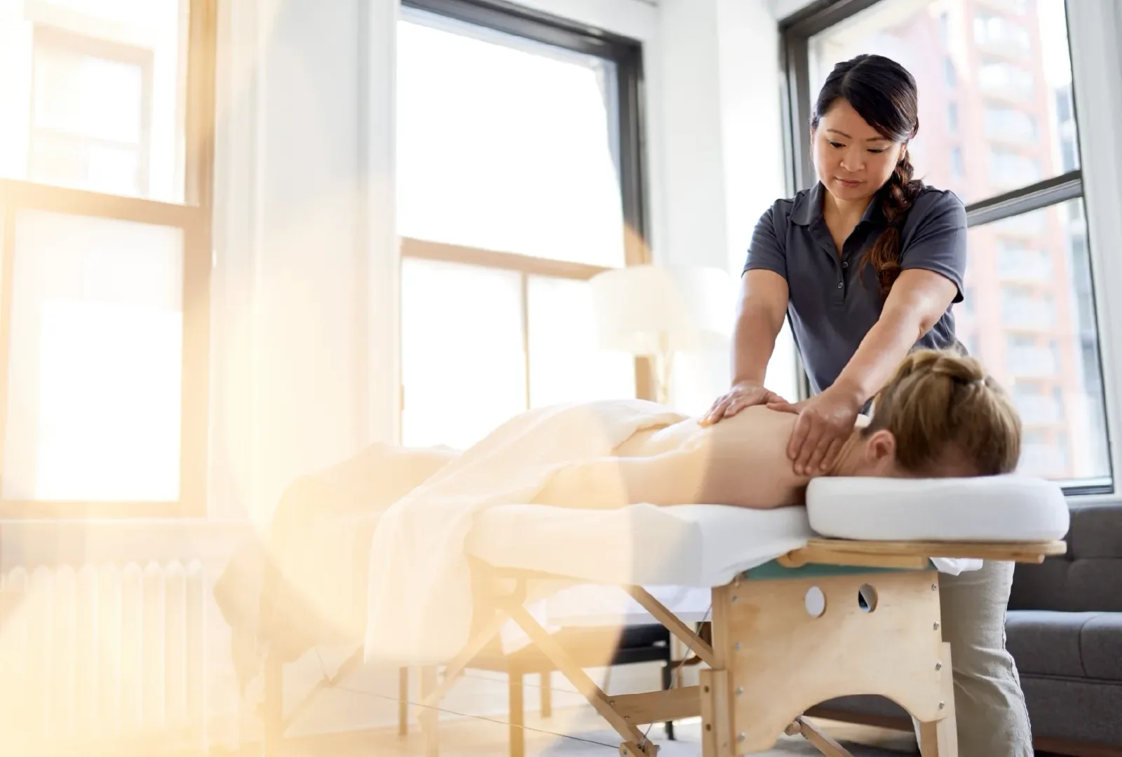 A therapist working on a client in Liu's massage studio